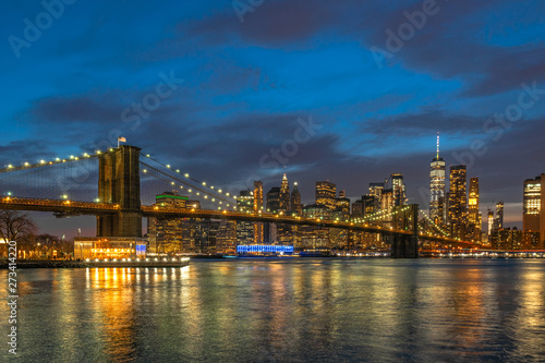 scene of New york Cityscape with Brooklyn Bridge over the east river at the twilight time  USA downtown skyline  Architecture and transportation concept