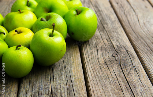 green apples on old wooden background