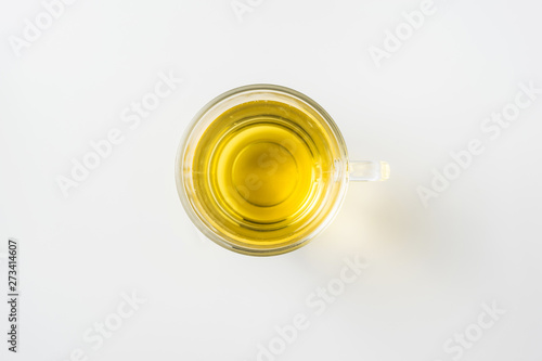 Top view of glass cup of hot tea on white background