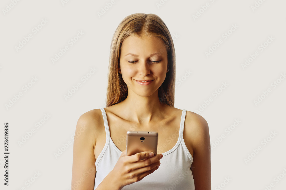 Happy smiling woman holds her cellphone Happy smiling woman holds her cellphone