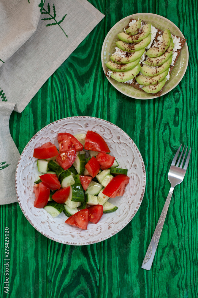 A healthy lunch: a salad and avocado sandwiches.