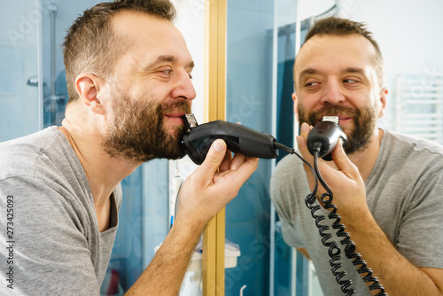 Man shaving trimming his beard