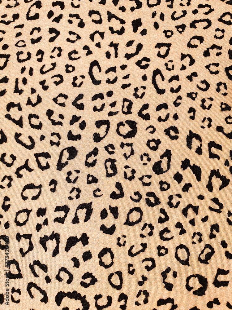 Beige leopard skin free style print background on clothing fabric
