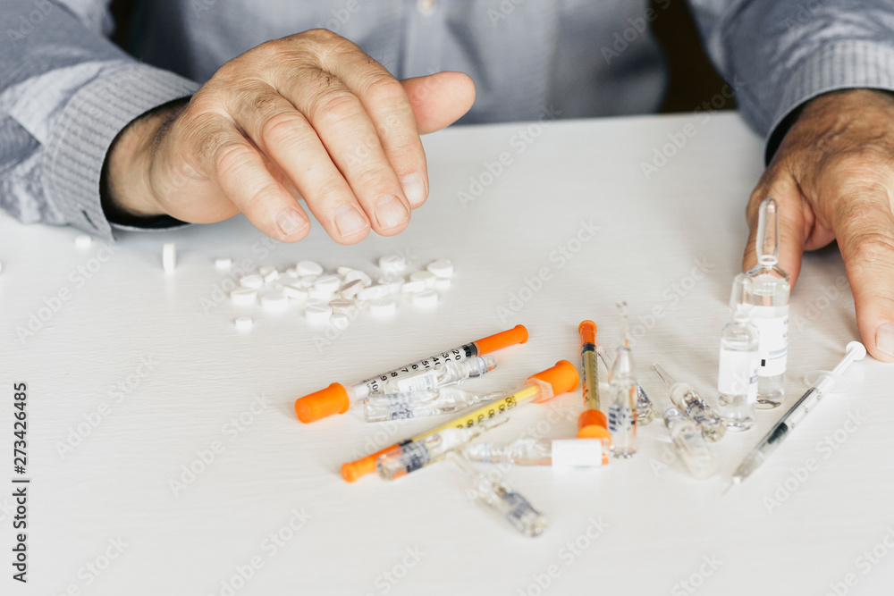 Medicine pills or capsules with man’s hands on white background with copy space. Medicine pills or capsules with man’s hands on white background with copy space.