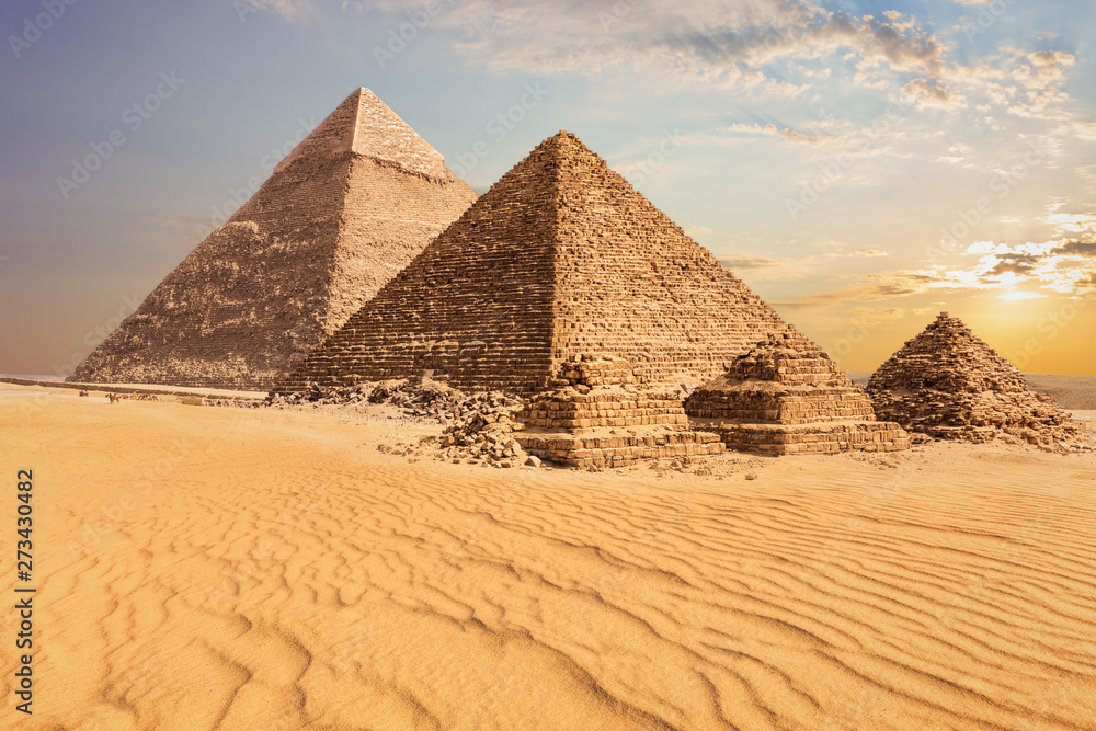 Beautiful sunset view of the Pyramid of Menkaure with companions and the Pyramid of Chephren, Egypt Beautiful sunset view of the Pyramid of Menkaure with companions and the Pyramid of Chephren, Egypt