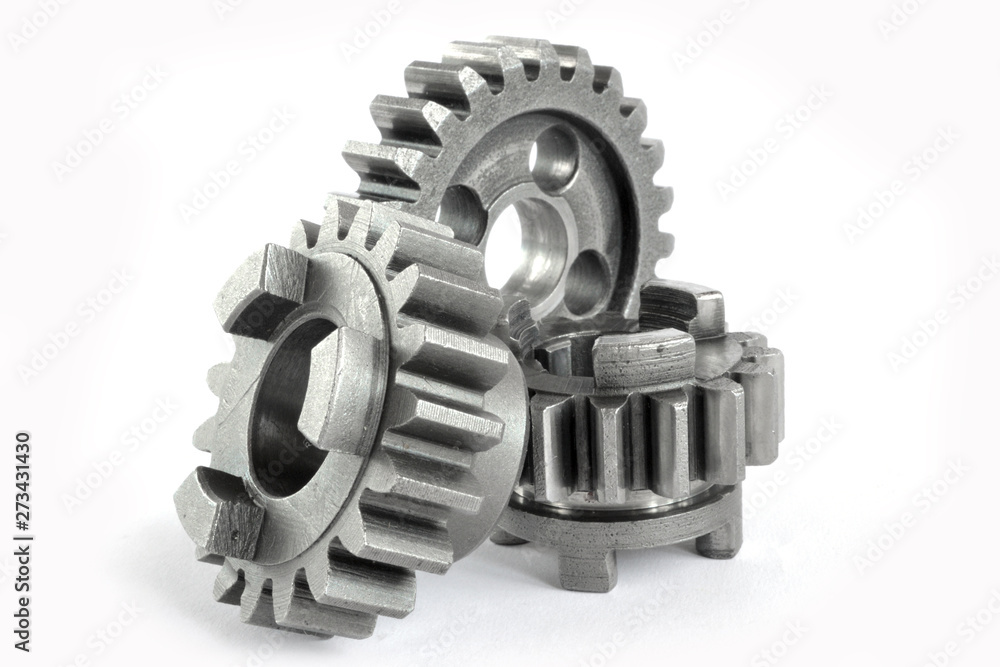 Three close-up metal gears on the white background. Three close-up metal gears on the white background.