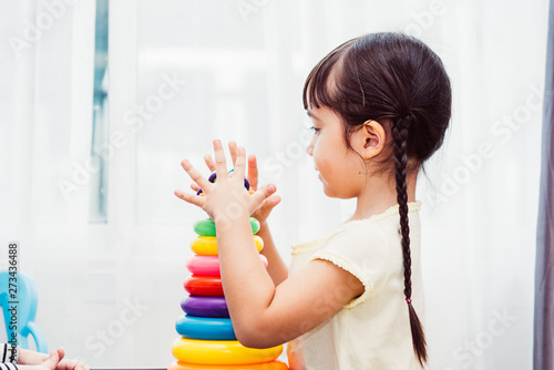 Beautiful baby girl kindergarten playing loop toy education