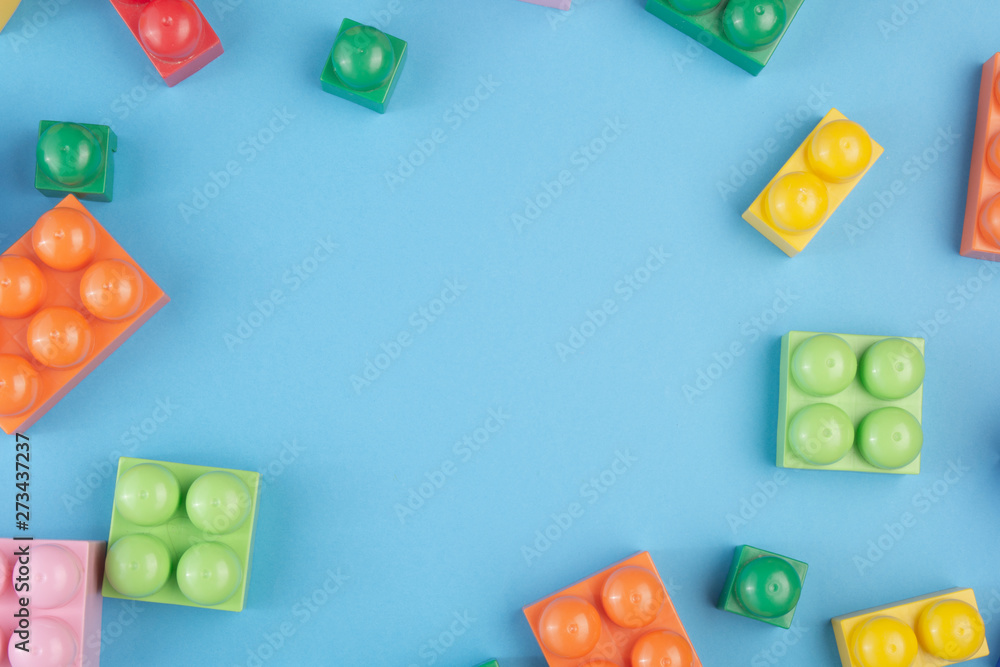 Constraction blocks and cubes on blue background. Copy space for text. Flat lay. Concept view. Constraction blocks and cubes on blue background. Copy space for text. Flat lay. Concept view.