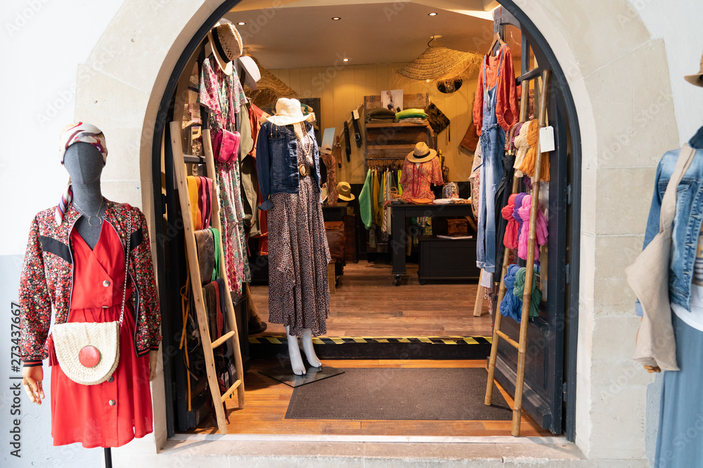 Colorful clothes in front and interior shop for sale