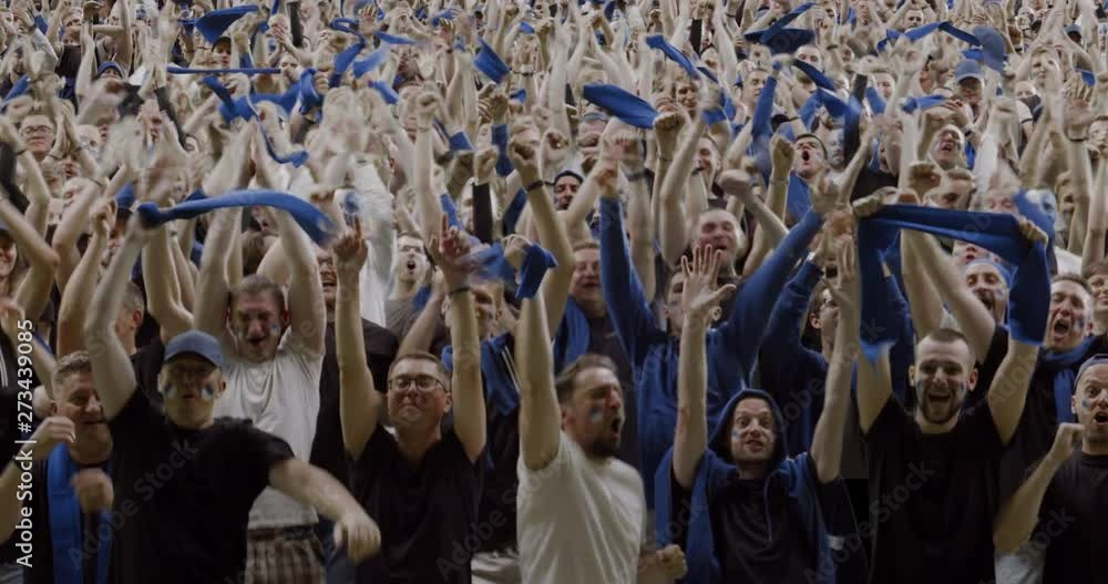 MODEL RELEASED Front view sports crowd fans wearing blue clothes celebrating during a sport event. 4K UHD ProRes 422 HQ MODEL RELEASED Front view sports crowd fans wearing blue clothes celebrating during a sport event. 4K UHD ProRes 422 HQ