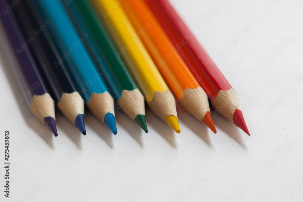 pencils of colors of the rainbow lies on a white background, sharpened pencils, bright colors, minimalism pencils of colors of the rainbow lies on a white background, sharpened pencils, bright colors, minimalism