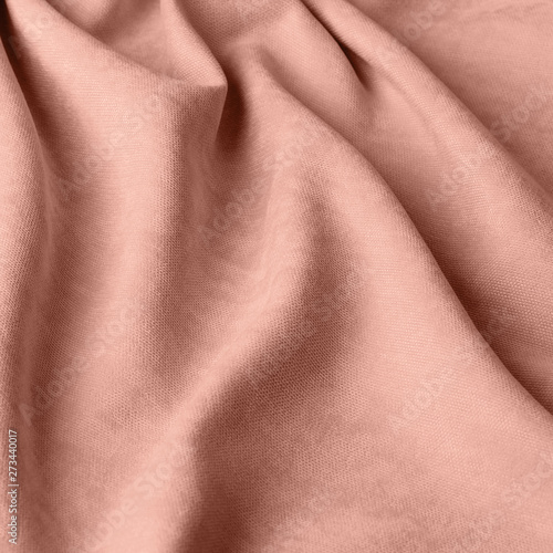 Monochrome decorative fabric velour peach. Fabric with natural texture. Velour textiles. Cloth backdrop