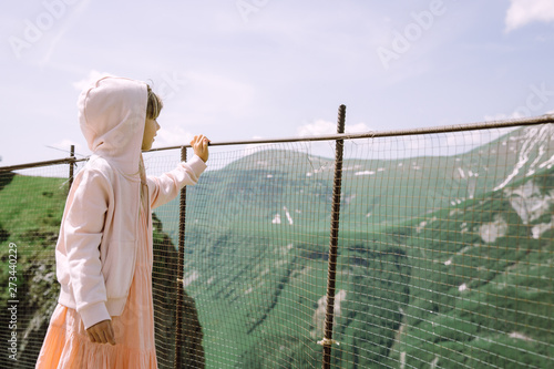 Little girl in the mountains of Gudauri and admiring the nature