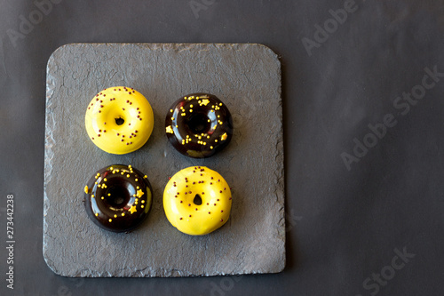 donuts in a glaze mix on a graphite stand