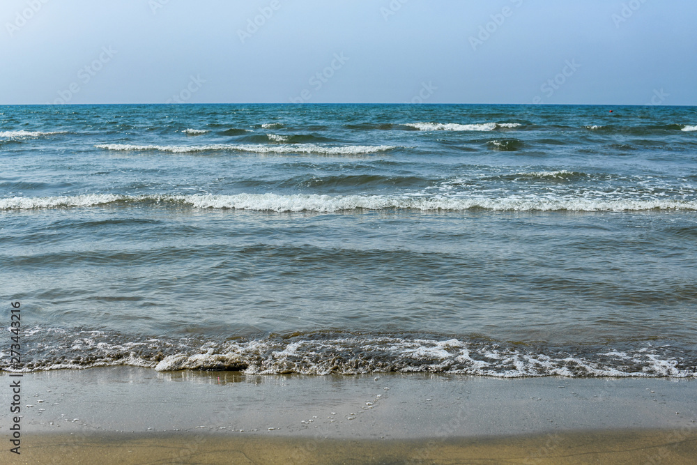 The sea waves on sand beach