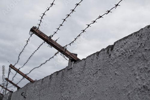 Concrete fence with barbed wire. Freedom, jail, prison, human rights, refugees concept. photo