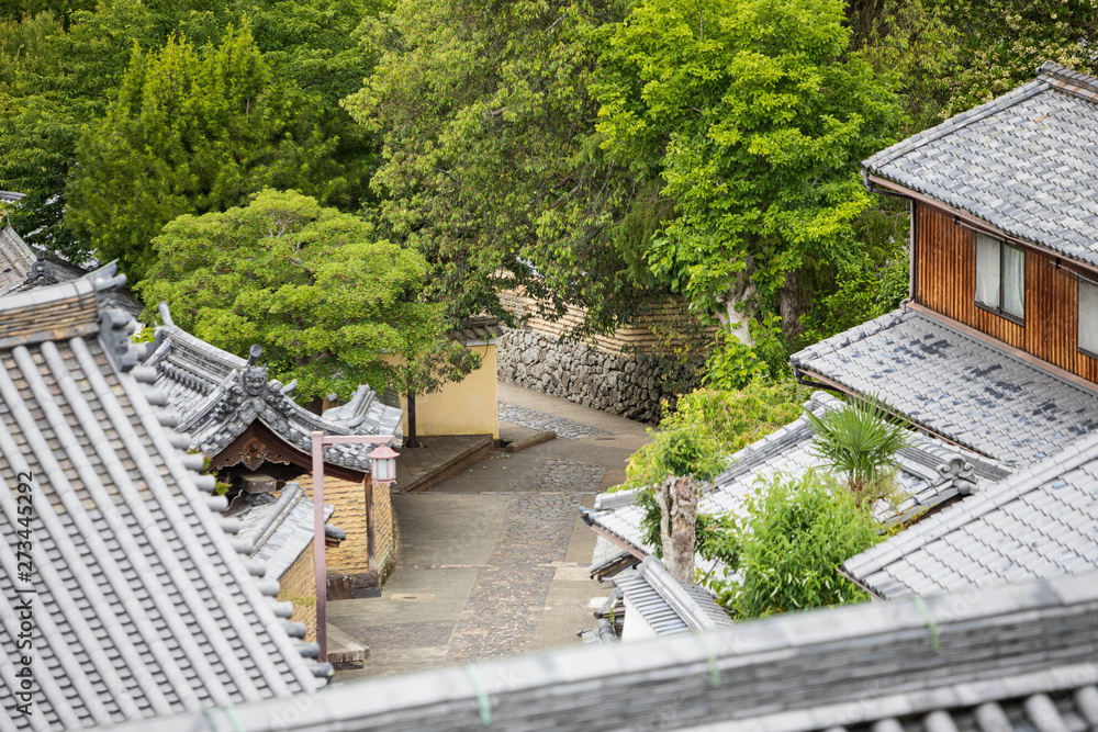 Overhead view of empty stone walkway through traditional Japanese wooden houses Overhead view of empty stone walkway through traditional Japanese wooden houses