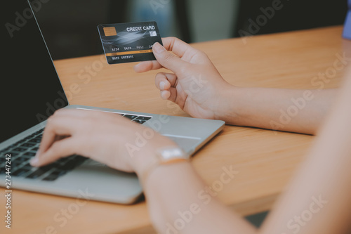 woman using computer & credit card for online shopping