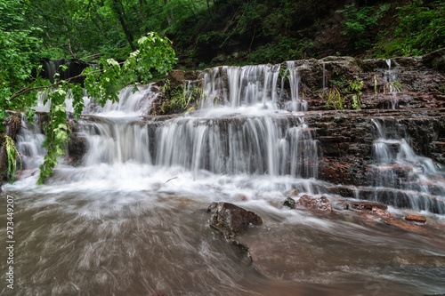 Mountain river waterfall landscape. Cascade of Dzhurynskyi waterfall.