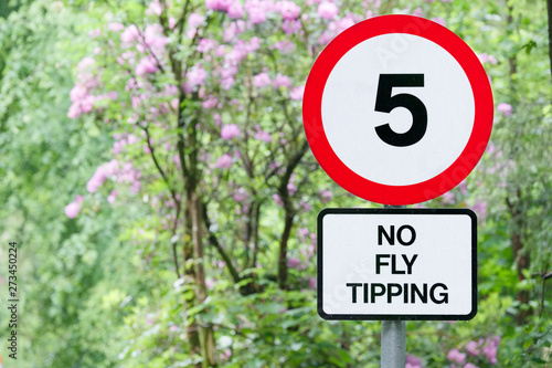 No fly tipping sign in beautiful landscape garden