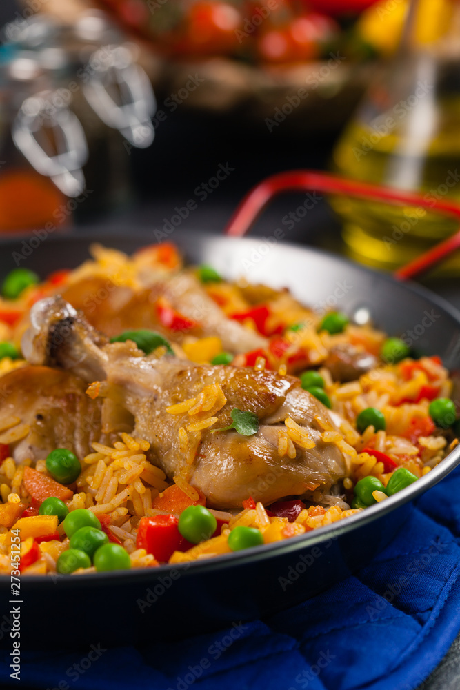 Arroz con pollo. Baked pieces of chicken with bone, rice with paprika and peas. Arroz con pollo. Baked pieces of chicken with bone, rice with paprika and peas.