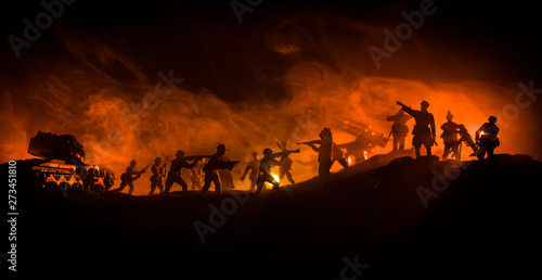 War Concept. Military silhouettes fighting scene on war fog sky background,