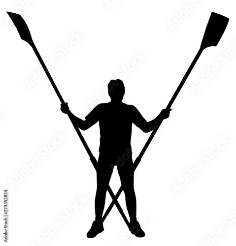 Male rower standing with crossed rowing oars