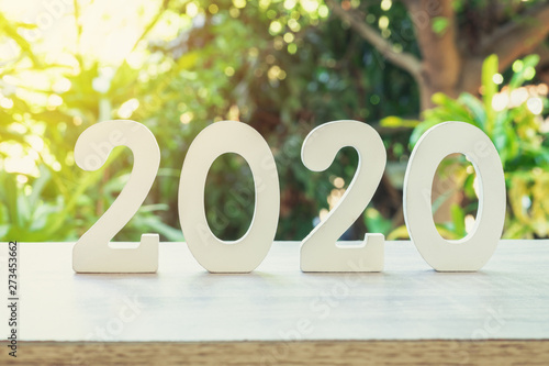 New year concept : wooden number 2020 for new year on wood table with sunlight.