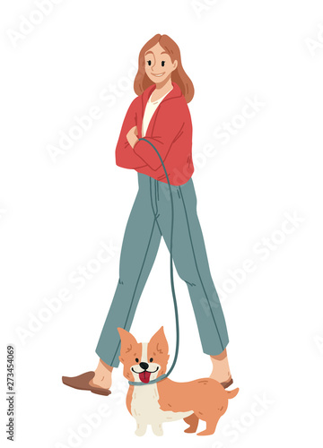 Girl walking with dog on a leash. Welsh Corgi.