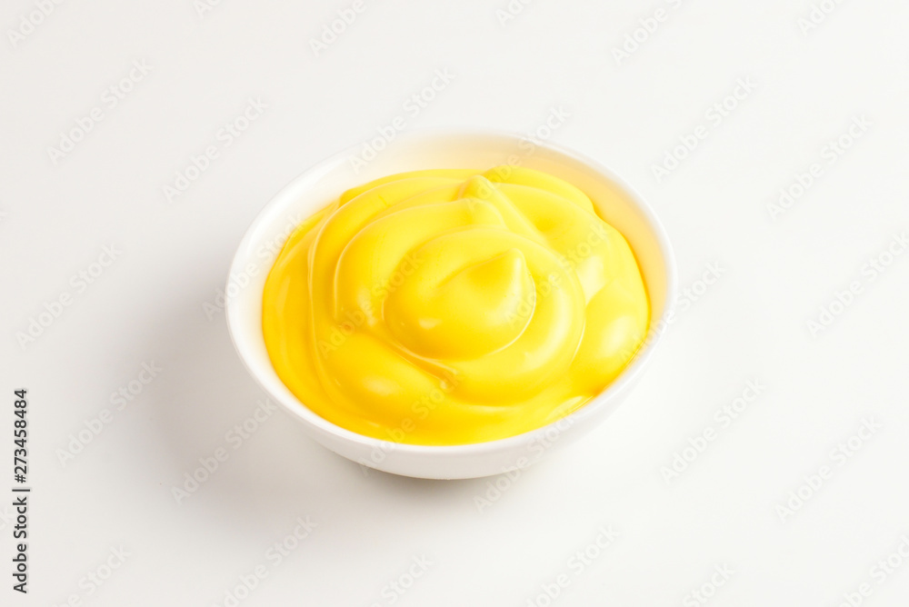 Cheese sauce in white plate on white background.