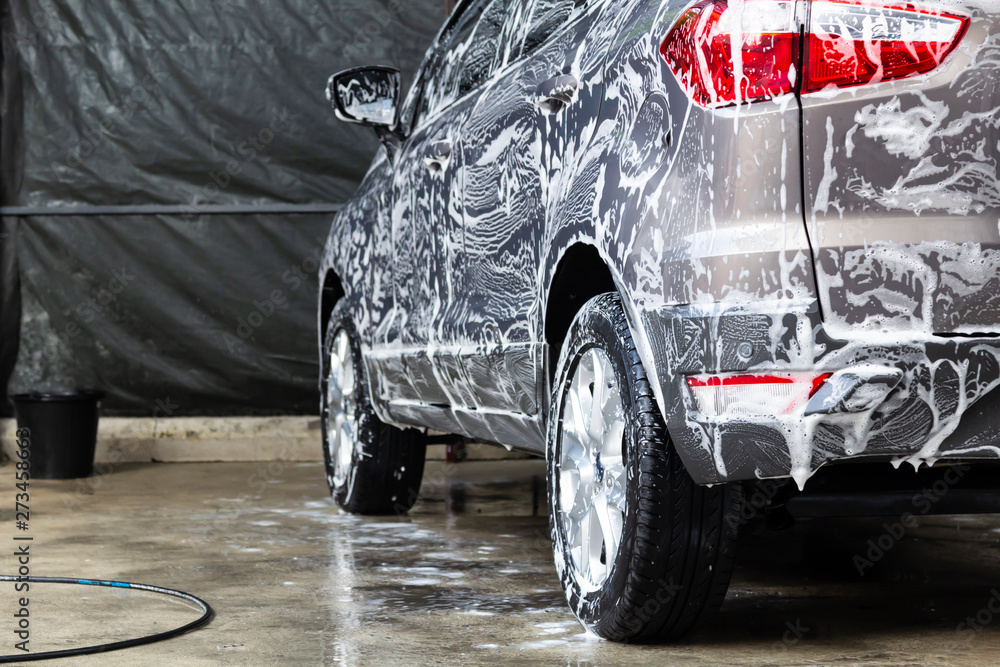 Manual car washing in car wash shop service. Stock Photo Adobe Stock