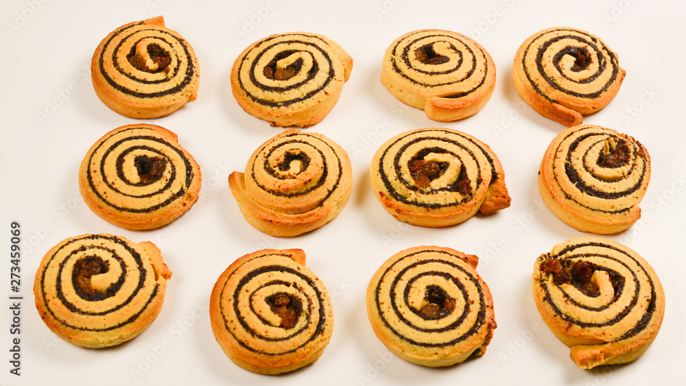 Baked cookies with raisins and poppy seeds isolated on white background. Baked cookies with raisins and poppy seeds isolated on white background.