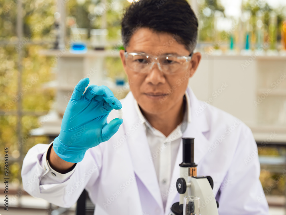 Scientist research the new medicine in laboratory; health care technology concept Scientist research the new medicine in laboratory; health care technology concept
