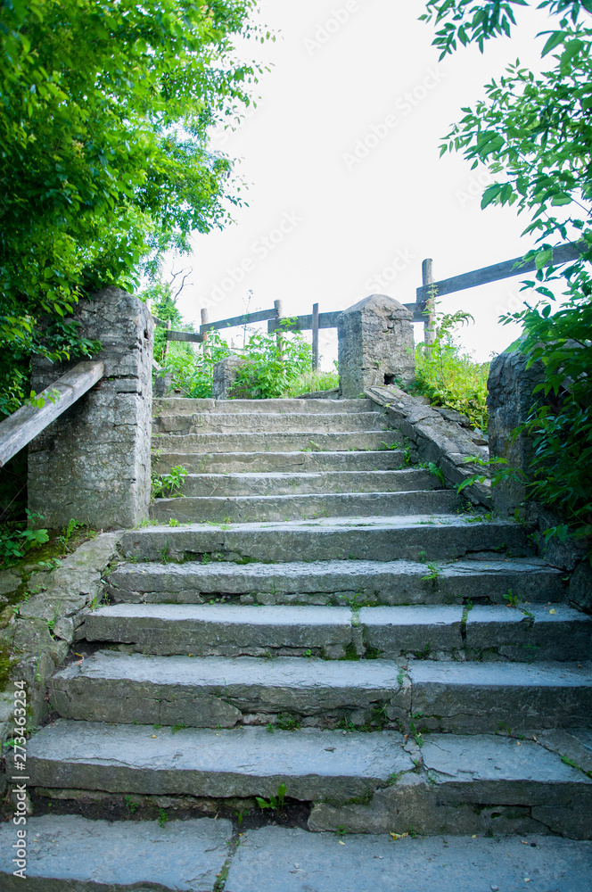 old staircase of large stones with columns on the sides leading up