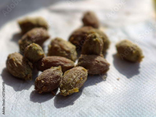 Olive pits or olive stones as the result of an eaten up appetizer in a restaurant. delicious olives were a starter of a meal in italy.