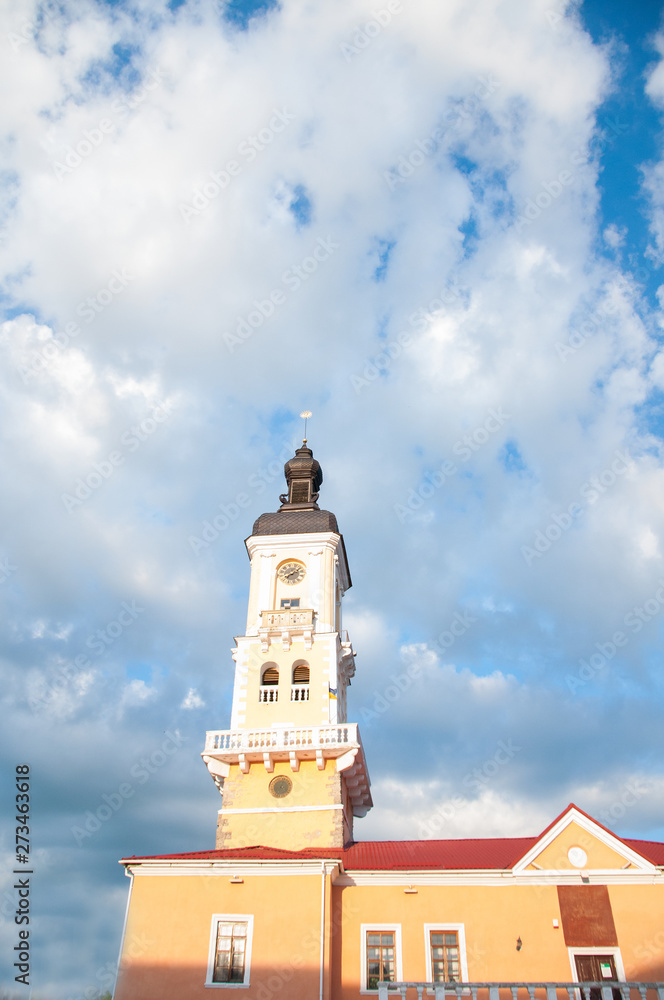 High old tower. The dome and spire of the temple against the blue sky and white clouds. Summer High old tower. The dome and spire of the temple against the blue sky and white clouds. Summer