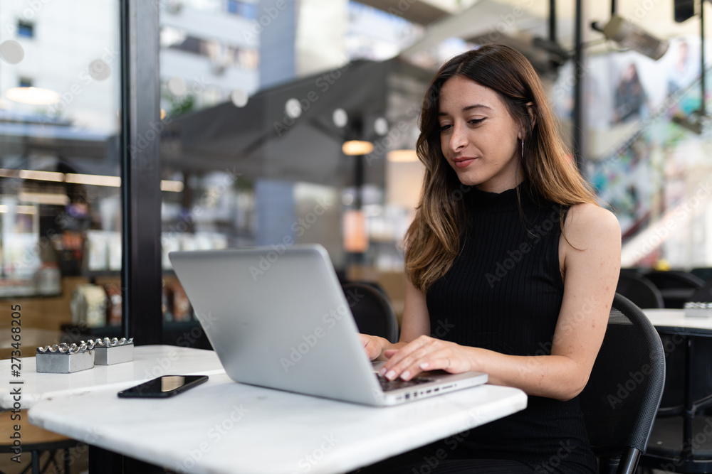 Business woman work process concept. Young woman working university project with generic design laptop. Blurred background, film effect.. Business woman work process concept. Young woman working university project with generic design laptop. Blurred background, film effect..