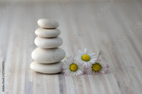 Harmony and balance, cairns, simple poise pebbles on wooden light white gray background, simplicity rock zen sculpture