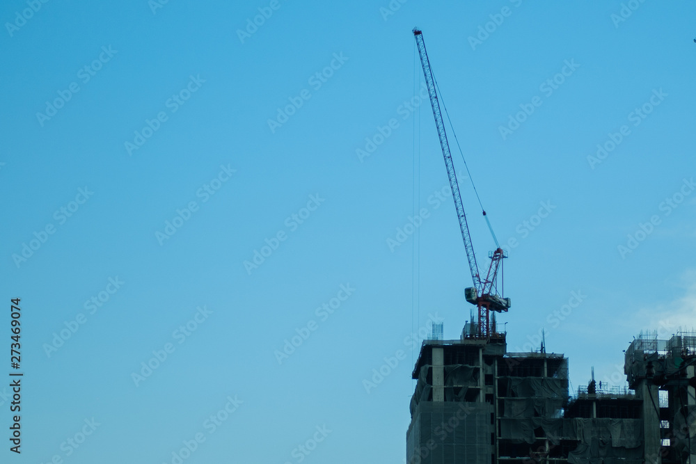 Crane on tall building during construction