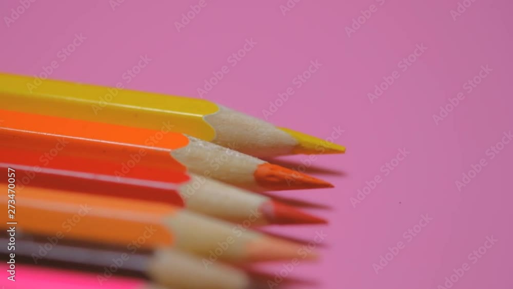 Color pencils on pink paper background. Macro video with colorful. Selective focus. Color pencils on pink paper background. Macro video with colorful. Selective focus.