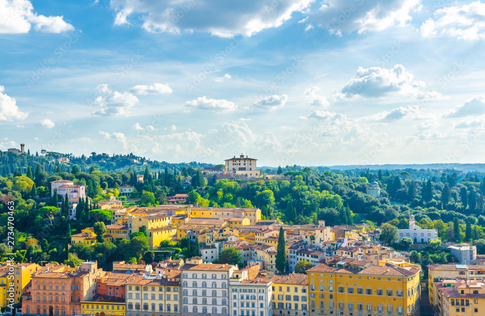 Top aerial panoramic view of Forte di Belvedere and green hills of Arcetri village, row of buildings, blue sky white clouds background, Florence city, Tuscany, Italy