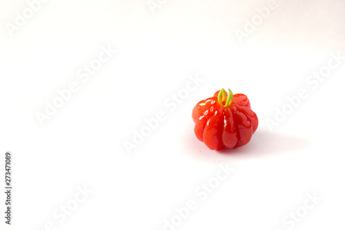 Pitanga fruit isolated on white. Brazilian cherry (Eugenia pitanga or Eugenia uniflora) is native to Brazil but today is a fruit cultivated in any tropical countries.  photo