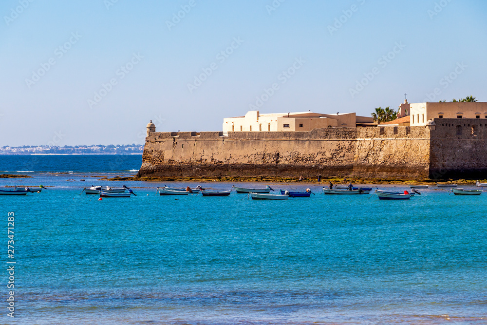 View of Castle of Santa Catalina with boats in Cadiz, Province of Cadiz, Andalusia, Spain from the causeway to the Castle of San Sebastian