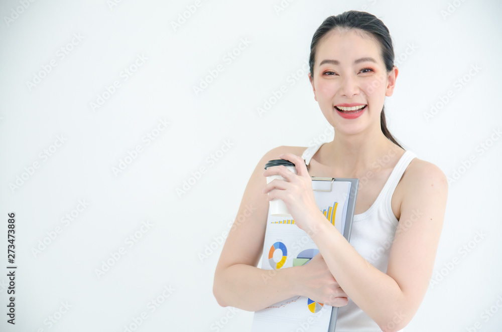 Pretty young asian business woman holding a cup of coffee and document files. Isolated Studio portrait on white background. Pretty young asian business woman holding a cup of coffee and document files. Isolated Studio portrait on white background.