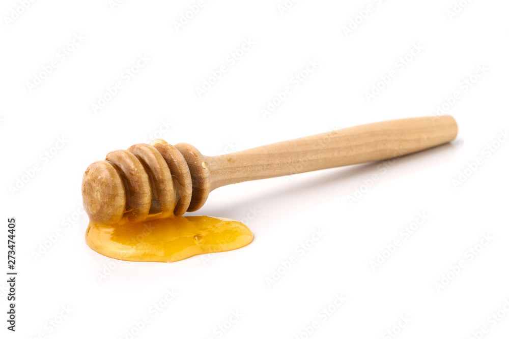 Wooden honey dipper with honey isolated on white Wooden honey dipper with honey isolated on white