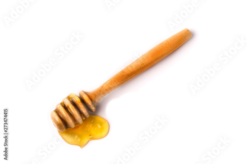Honey stick with flowing honey isolated on white background