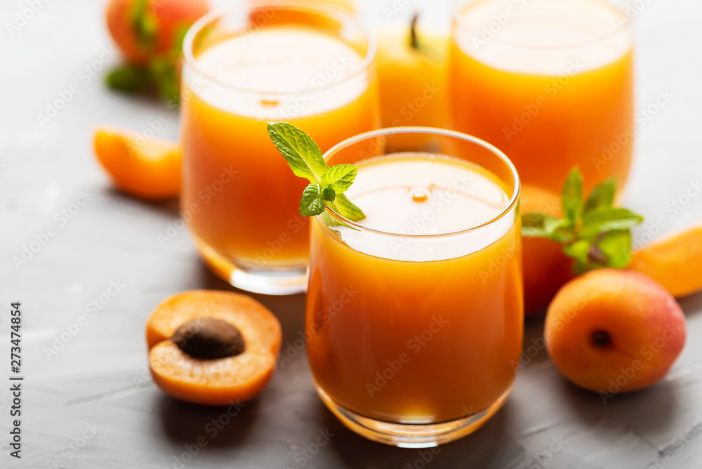 Fresh apricot juice on the marble table Fresh apricot juice on the marble table