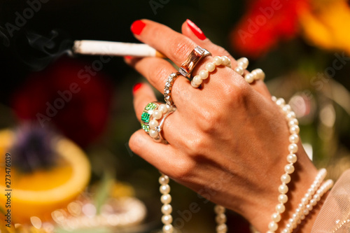 Cropped Hand holding Cigarette with Jewellery