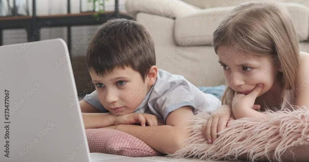Little brother and sister watching movie at home Little brother and sister watching movie at home