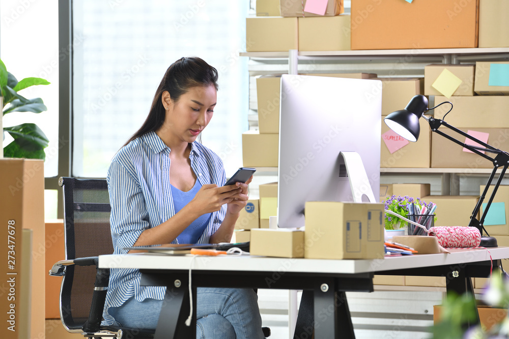 Young Asian woman entrepreneur/ Business owner working with computer at home Young Asian woman entrepreneur/ Business owner working with computer at home